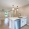 Spacious and well lit kitchen with wood flooring and stainless steel appliances