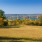 Landscape photo of the river and a large grassy area 